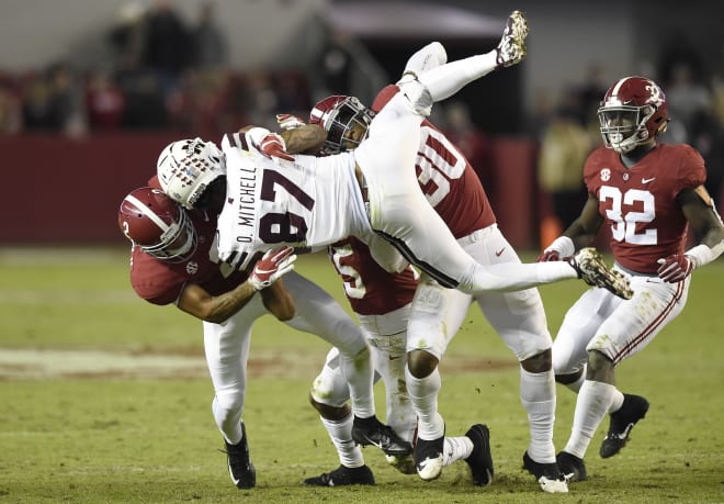 Mississippi State Bulldogs wide receiver Osirus Mitchell (87) gets body slammed by Alabama Crimson Tide defensive back Patrick Surtain II (2) and linebacker Mack Wilson (30) during the fourth quarter at Bryant-Denny Stadium. Photo | Imagn