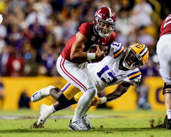 Alabama Crimson Tide quarterback Bryce Young (9) scrambles against LSU Tigers safety Joe Foucha (13) during the second half at Tiger Stadium. Photo | Stephen Lew-USA TODAY Sports