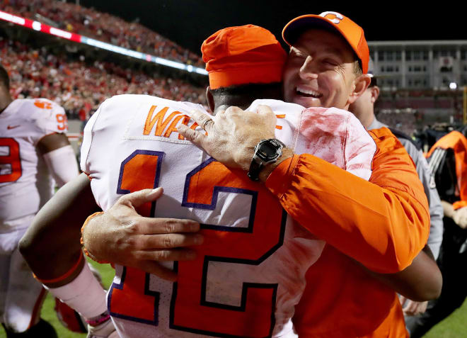 Clemson head coach Dabo Swinney embraces defensive back K'Von Wallace in Carter-Finley Stadium Saturday night after the Tigers' beat N.C. State 38-31.