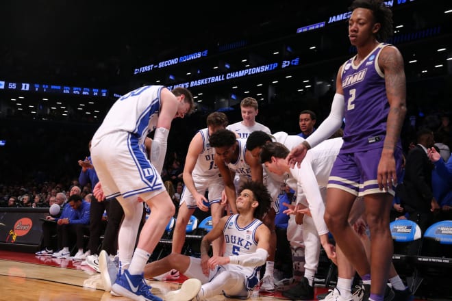Duke players celebrate around Tyrese Proctor after he made a 3-pointer against James Madison on Sunday. 
