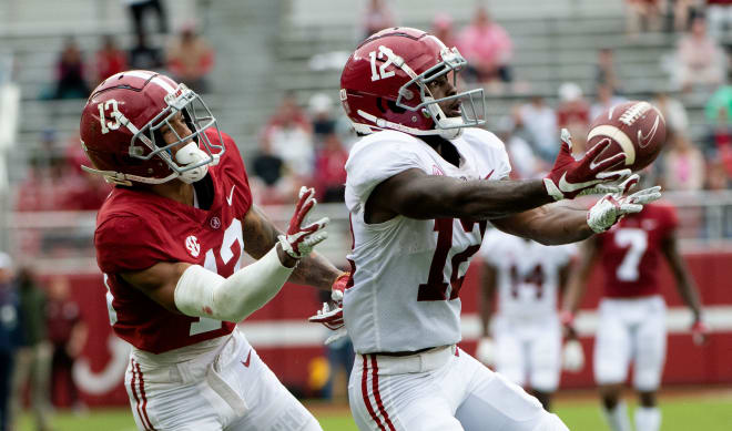White wide receiver Christian Leary (12) catches a touchdown pass from White quarterback Jalen Milroe (2) with Crimson defensive back Malachi Moore (13) covering during the A-Day game at Bryant-Denny Stadium. Photo | Gary Cosby Jr.-USA TODAY Sports