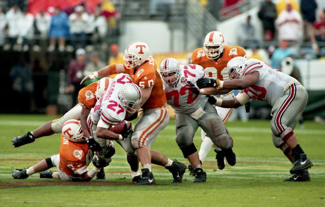 Heisman Trophy winner Eddie George (27) of Ohio State is dragged down by a trio of Tennessee defenders during the Citrus Bowl game in Orlando, Fla., Jan. 1, 1996. Tennessee came out on top 20-14.