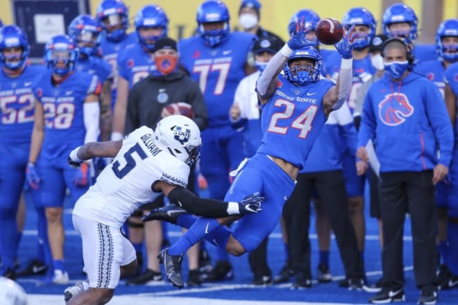 Boise State running back George Holani (24) catches the ball in front of Utah State linebacker Cash Gilliam (5) during the first half of an NCAA college football game Saturday, Oct. 24, 2020, in Boise, Idaho. (AP Photo/Steve Conner)