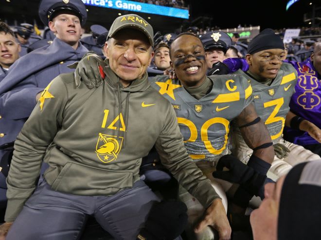 Army Football 2 time Captain and safety Marquel Broughton celebrates with HC Jeff Monken after Decembers' win over Navy