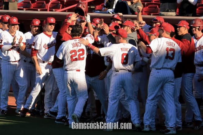 John Jones is greeted by teammates after his first-inning homer on Friday