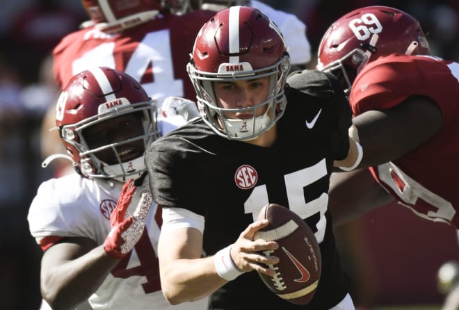 Crimson team quarterback Ty Simpson (15) runs away from a rush by White team linebacker Qua Russaw (49) during the A-Day game at Bryant-Denny Stadium. Photo | Gary Cosby-USA TODAY Sports