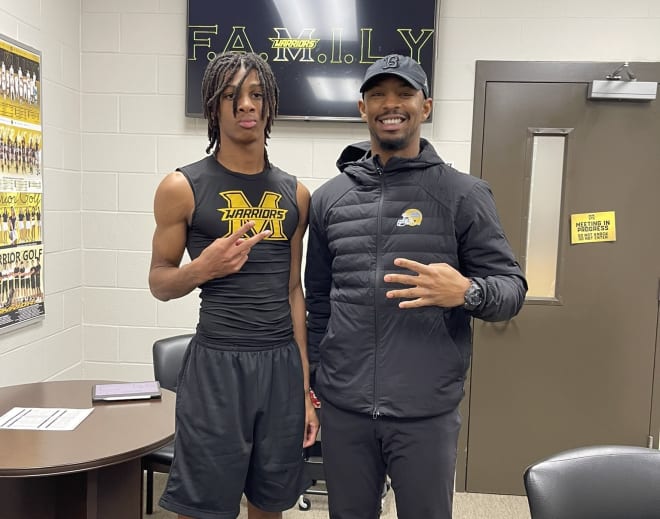 Chase Coleman (left) with UCLA cornerbacks coach Kodi Whitfield during a visit to Coleman’s high school in Texas in late January.