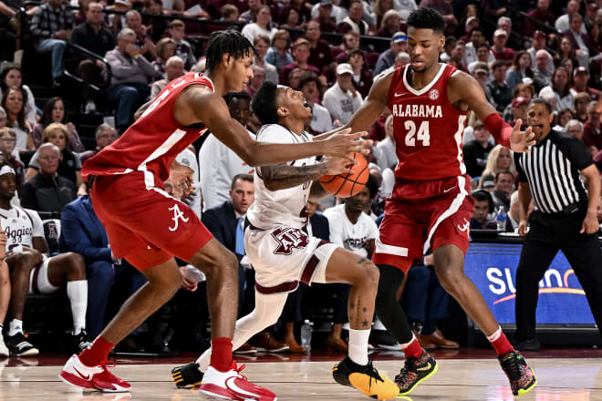 Texas A&M Aggies guard Wade Taylor IV (4) is doubled teamed by Alabama Crimson Tide forwards Brandon Miller (24) and Noah Clowney (15) during the second half at Reed Arena. Photo | Maria Lysaker-USA TODAY Sports
