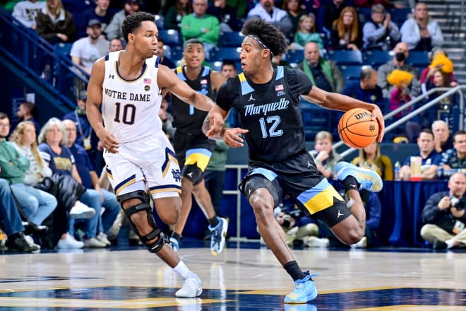 Marquette forward Olivier-Maxence Prosper (12) dribbles as ND guard Marcus Hammond (10) defends in the second half at Purcell Pavilion. 