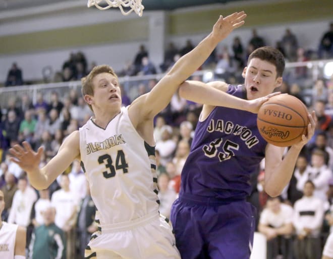 2017 forward Kyle Young (right) of Jackson High School in Massillon, Ohio, was watched by Indiana coach Tom Crean during the season.