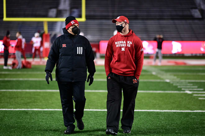 Scott Frost talks with Greg Schiano at Rutgers a little over a year ago for a late December night game. 