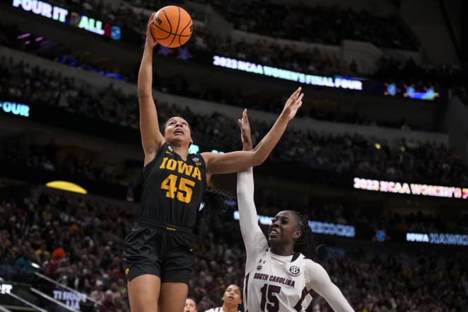 Mar 31, 2023; Dallas, TX, USA; Iowa Hawkeyes forward Hannah Stuelke (45) drives to the basket against South Carolina Gamecocks forward Laeticia Amihere (15) in the first half in semifinals of the women's Final Four of the 2023 NCAA Tournament at American Airlines Center. 