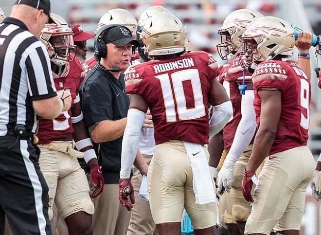 FSU defensive coordinator Adam Fuller talks with defensive back Jammie Robinson earlier this season.