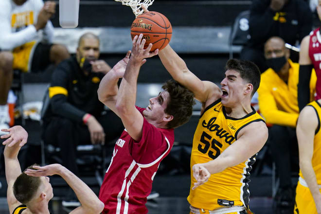 Iowa center Luka Garza (55) blocks the shot of Wisconsin forward Nate Reuvers (35) in the first half of the Hawkeys' 62-57 victory.