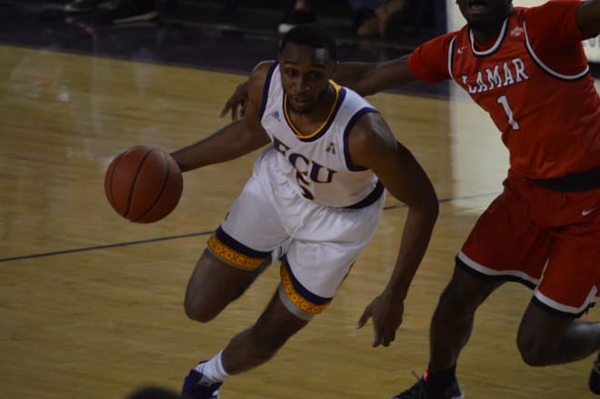 Ty Foster drives past Lamar's Mike Kolawole for two of his twelve points in ECU's overtime win over the Cardinals.