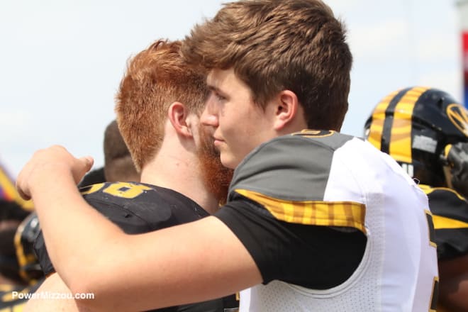 Eric Beisel and Drew Lock embrace after the game