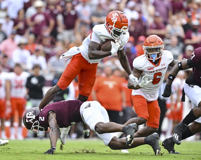 Texas A&M Aggies defensive back Denver Harris (2) upends Sam Houston State Bearkats wide receiver Ife Adeyi (2) during the first quarter at Kyle Field. Photo | Maria Lysaker-USA TODAY Sports