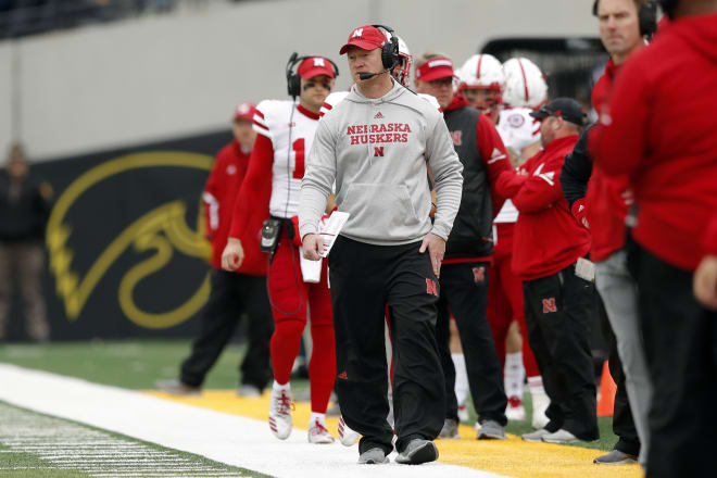 Nebraska quarterback Matt Masker following head coach Scott Frost down the sideline.