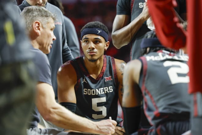 Rivaldo Soares taking direction from Head Coach Porter Moser in Oklahoma's matchup with West Virginia