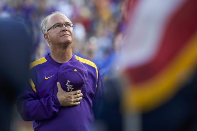 LSU Tigers head coach Paul Mainieri watches the military flyover during the National Anthem prior to a College World Series game agianst Florida  on June 26, 2017 in Omaha., Neb.