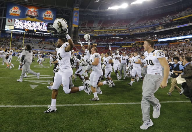 UCF players rush the field following their 52-42 Fiesta Bowl victory against Baylor on Jan. 1, 2014.