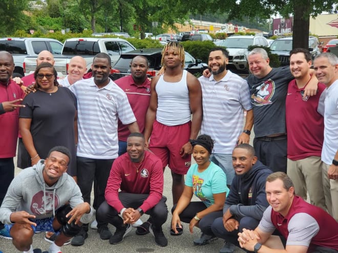 New FSU commit Trevion Williams poses with coaches, staff and players at FSU on Saturday.