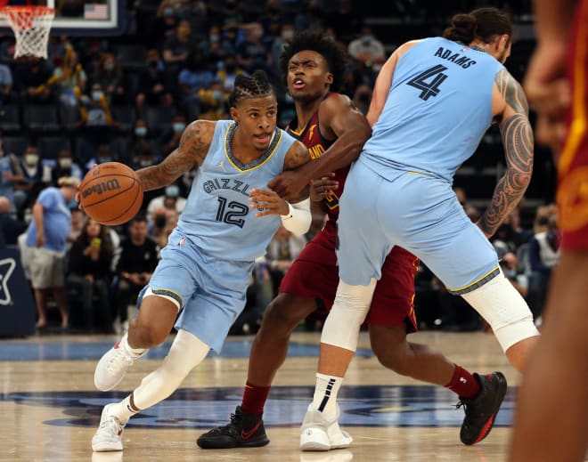 Memphis Grizzles guard Ja Morant (12) dribbles around a screen set by center Steven Adams (4) against Cleveland Cavaliers guard Collin Sexton (2) during the second half at FedExForum. Mandatory Credit: Petre Thomas-USA TODAY Sports