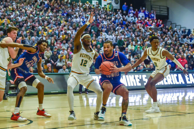 Vermont's Shamir Bogues defends UMass Lowell's Ayinde Hikim on Saturday. 