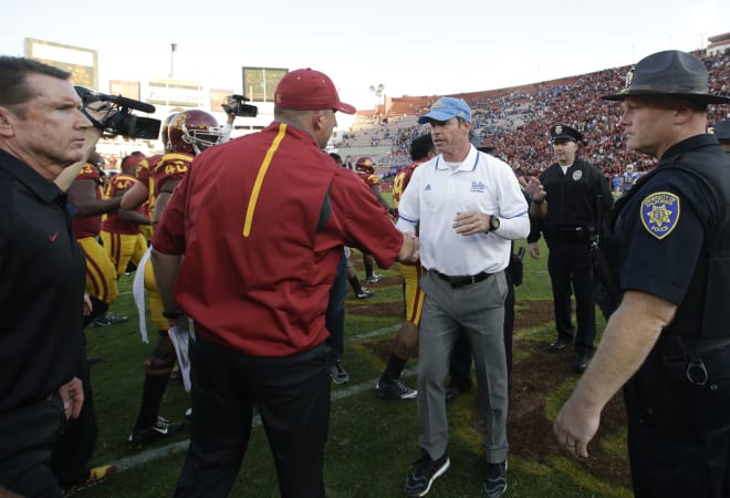 USC's Clay Helton, left, and Jim Mora 
