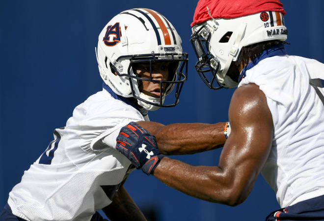 Jaylin Simpson (left) goes against Owen Pappoe (right) in a drill.