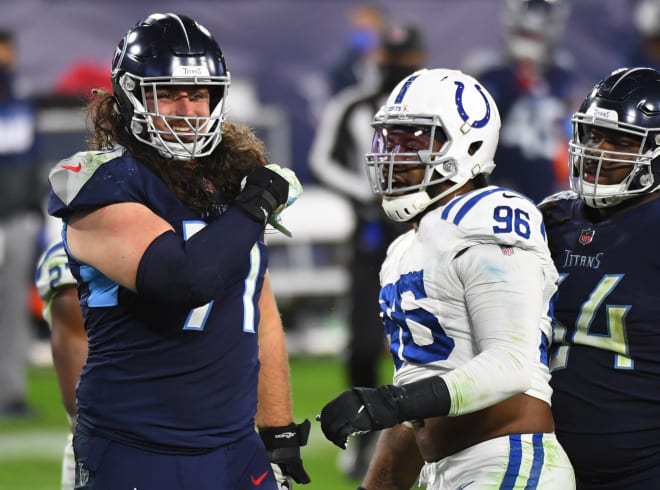 Tennessee Titans offensive tackle Dennis Kelly (71) and Indianapolis Colts defensive tackle Denico Autry (96) exchange words after a play during the second half at Nissan Stadium. 