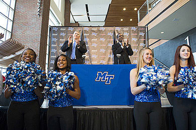 Athletic director Chris Massaro (left) and university president Sidney McPhee (right) celebrate MTSU's entrance into Conference USA