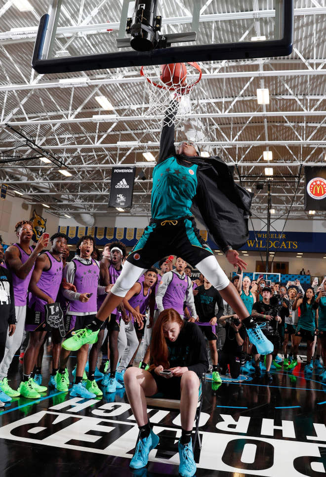 Francesca Belibi dunks over Ashten Prechtel Monday night to win the McDonald All-American dunk contest. Belibi and Prechtel will be freshman at Stanford next season.