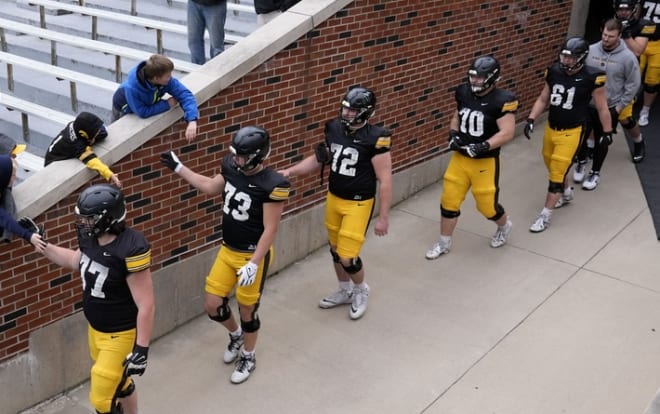 Iowa linemen Connor Colby, Kyson Van Vugt, Kale Krogh, Cael Winter and others enter Kinnick Stadium before Iowa's open practice Saturday.