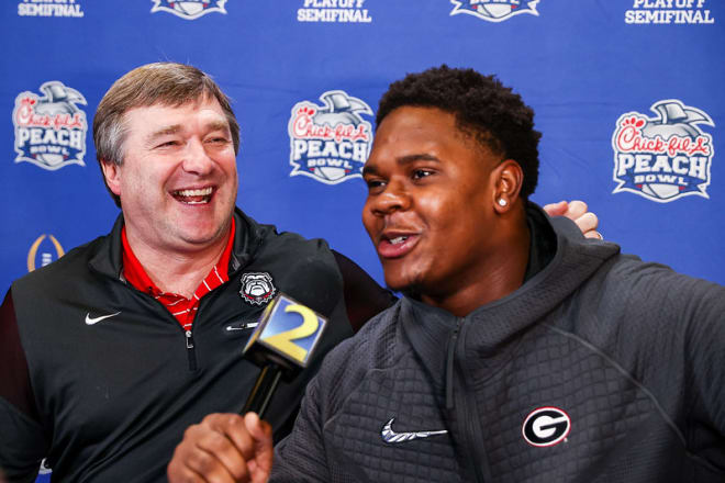Warren Brinson yucks it up with Kirby Smart prior to the Chick-fil-A Bowl.