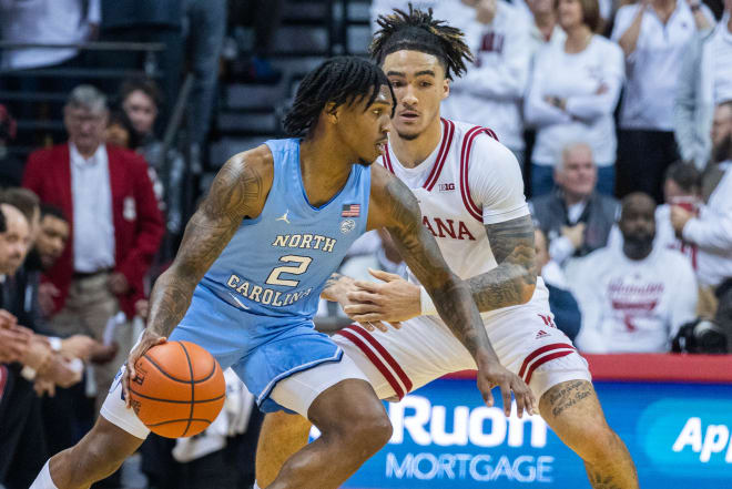 Nov 30, 2022; Bloomington, Indiana, USA; North Carolina Tar Heels guard Caleb Love (2) dribbles the ball while Indiana Hoosiers guard Jalen Hood-Schifino (1) defends in the first half at Simon Skjodt Assembly Hall. Trevor Ruszkowski-USA TODAY Sports