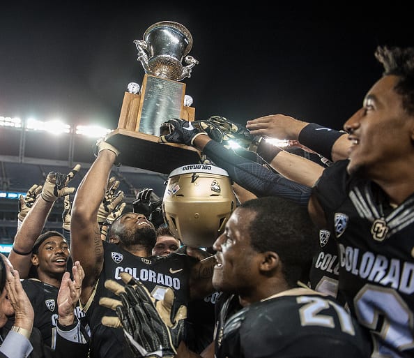 DENVER, CO - SEPTEMBER 2: Colorado Buffaloes players celebrate as they hoist the Centennial Trophy after defeating the Colorado State Rams 44-7 at Sports Authority Field at Mile High on September 2, 2016 in Denver, Colorado. (Photo by Dustin Bradford/Getty Images)