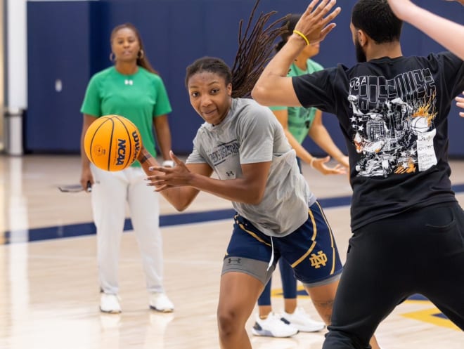 Notre  Dame women's basketball coach Niele Ivey (left) looks on as incoming transfer Liatu King acclimates to her new team and surroundings.