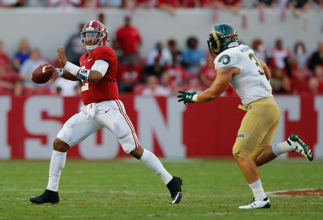 Alabama quarterback Jalen Hurts, left, rolls out for a pass against Colorado State. Photo | Getty Images 