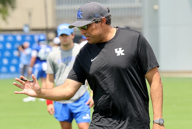 New Kentucky offensive coordinator Bush Hamdan explained a drill during Friday's practice.