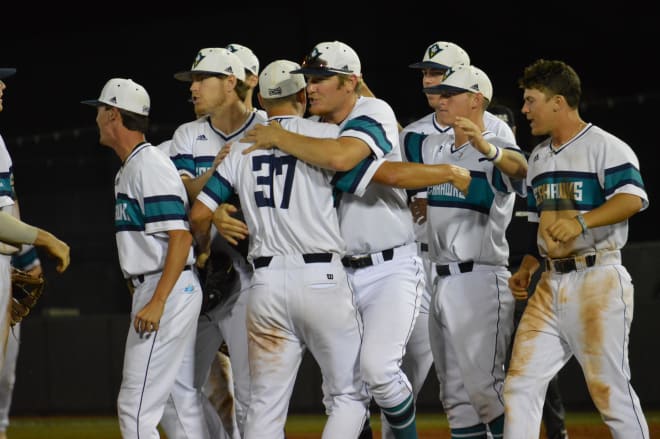 Seahawk players celebrate after beating ECU 9-7 to keep their hopes alive in the Greenville NCAA Regional.