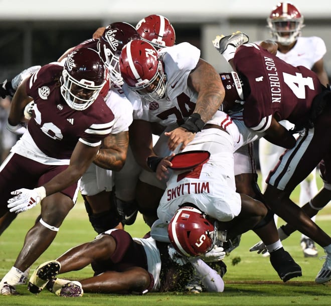 Mississippi State Bulldogs cornerback DeCarlos Nicholson (4) flips Alabama Crimson Tide running back Roydell Williams (5) on his head in the middle of the line in Davis Wade Stadium at Mississippi State University. Alabama defeated Mississippi State 40-17. Photo | Gary Cosby Jr.-Tuscaloosa News