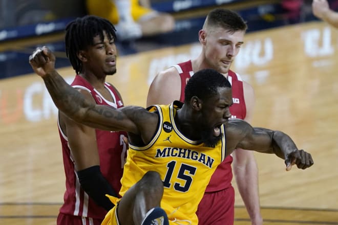 Michigan guard Chaundee Brown (15) reacts next to Wisconsin forwards Aleem Ford, left, and Micah Potter after a dunk in Michigan's 77-54 victory.