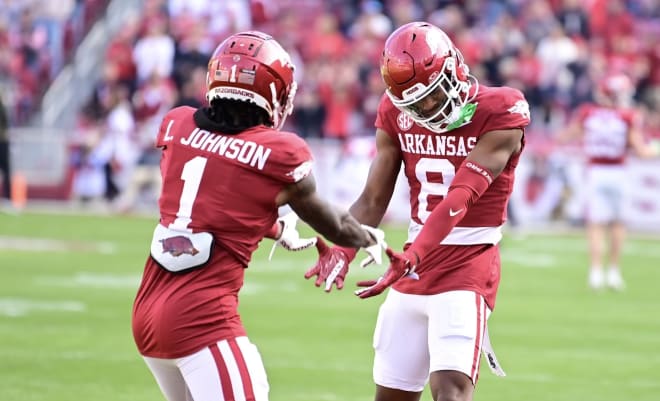 Arkansas defensive backs Lorando Johnson and Jayden Johnson celebrate together during the first half of Saturday's game against Auburn.
