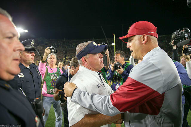 Brian Kelly and USC head coach Clay Helton converse at the end of last night's 49-14 Irish rout. 