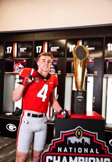2023 Inside Linebacker target Whit Weeks poses with Georgia's National Championship trophy.