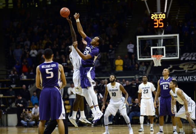 Robert Upshaw (right) jumping for the open tipoff vs Colorado