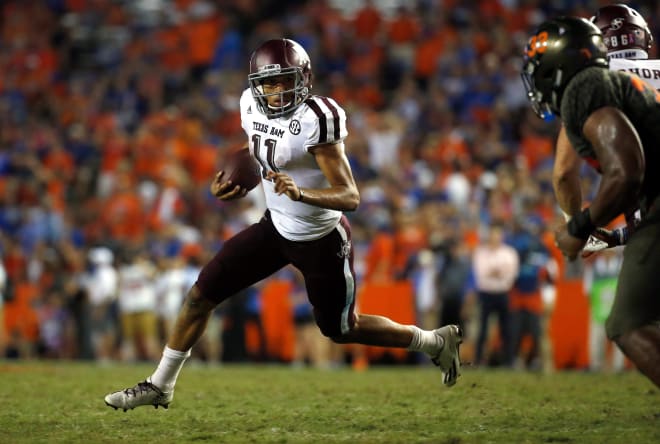 Aggie quarterback Kellen Mond evades the defense with his legs.