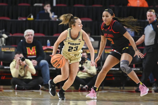 Jan 14, 2024; College Park, Maryland, USA; Purdue Boilermakers guard Abbey Ellis (23) looks to passs as Maryland Terrapins guard Brinae Alexander (5) defends during the first half at Xfinity Center. Mandatory Credit: Tommy Gilligan-USA TODAY Sports