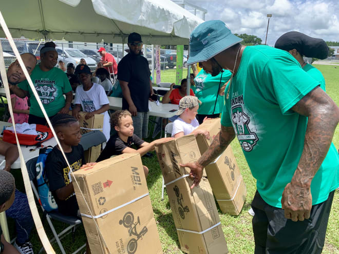 Former FSU star Nigel Bradham hands out bicycles to campers at his free youth football camp on Saturday.